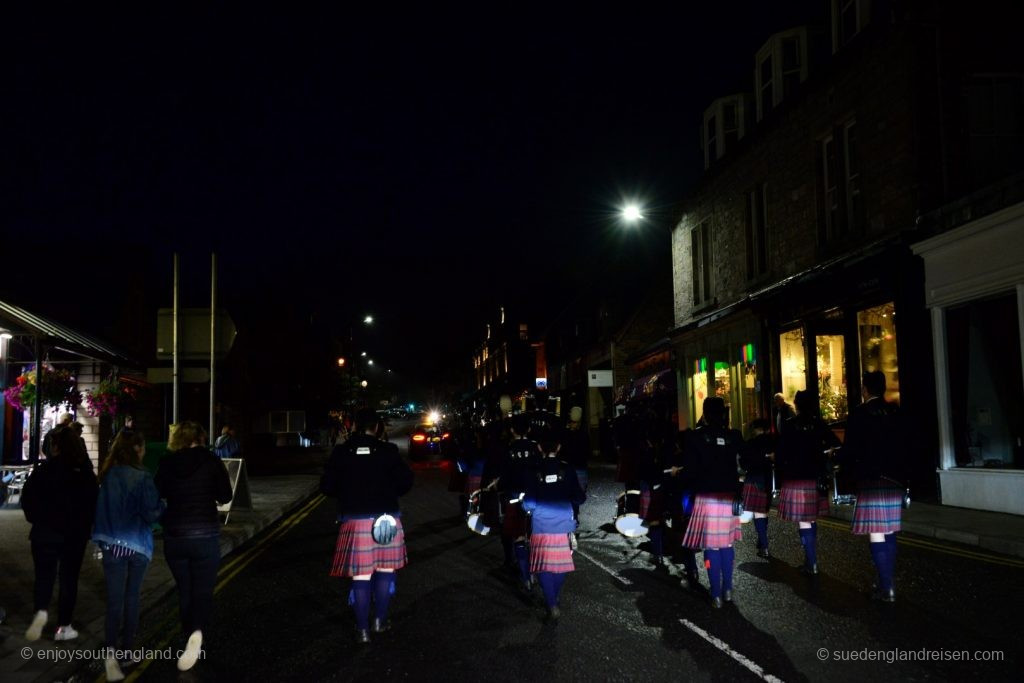 Spectators follow the Pipes and Drums back onto Pitlochry High Street